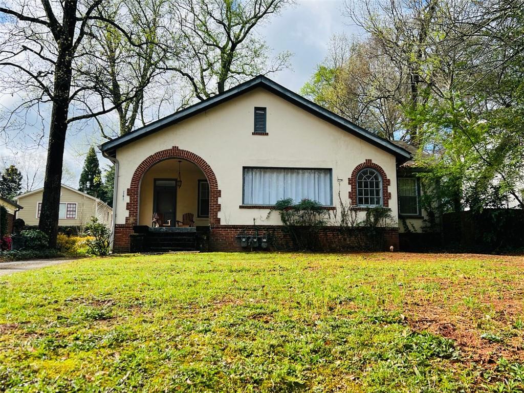 2243 East Lake Road Northeast Atlanta, GA 30307 - Photo 1 of 1 a front view of house with yard and swimming pool
