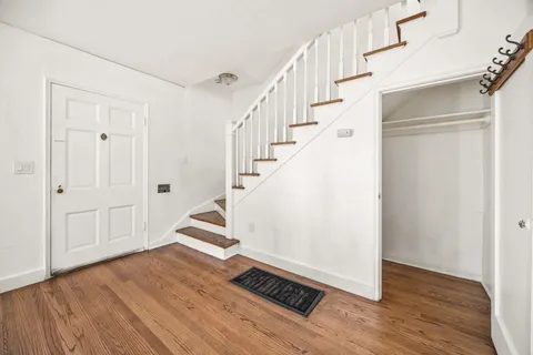 a view of an entryway with wooden floor