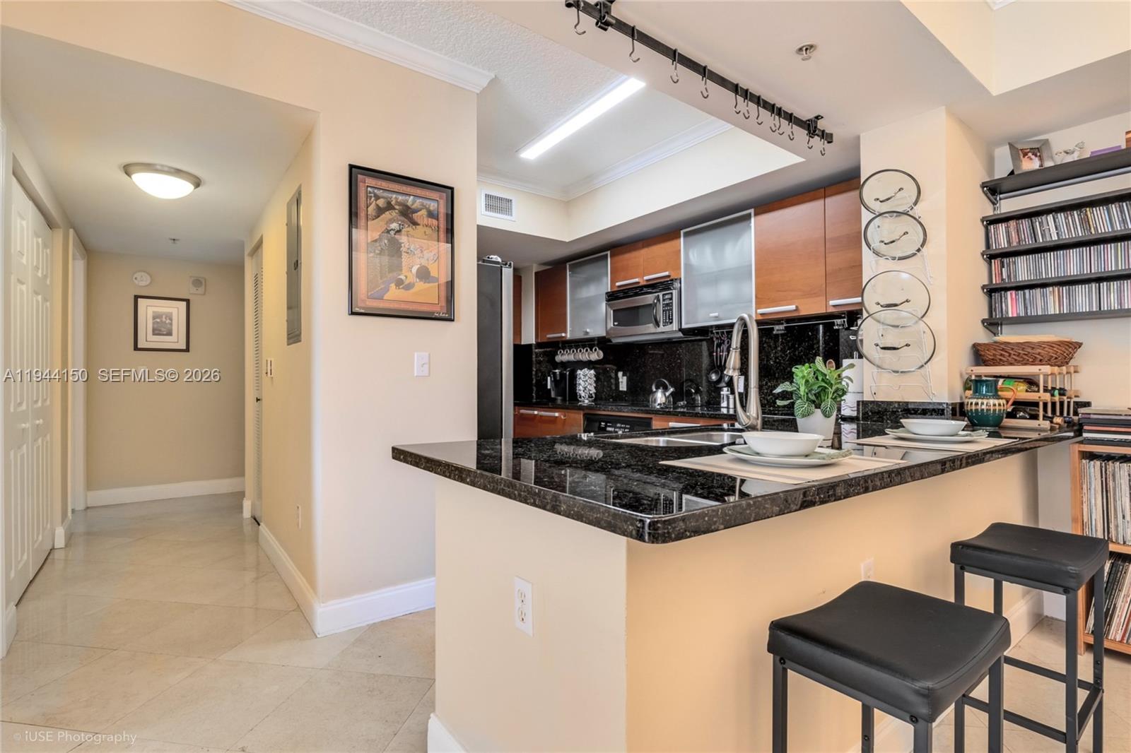 2030 Douglas Road, Unit 511 Coral Gables, FL 33134 - Photo 4 of 19 a kitchen with stainless steel appliances granite countertop a stove and cabinets