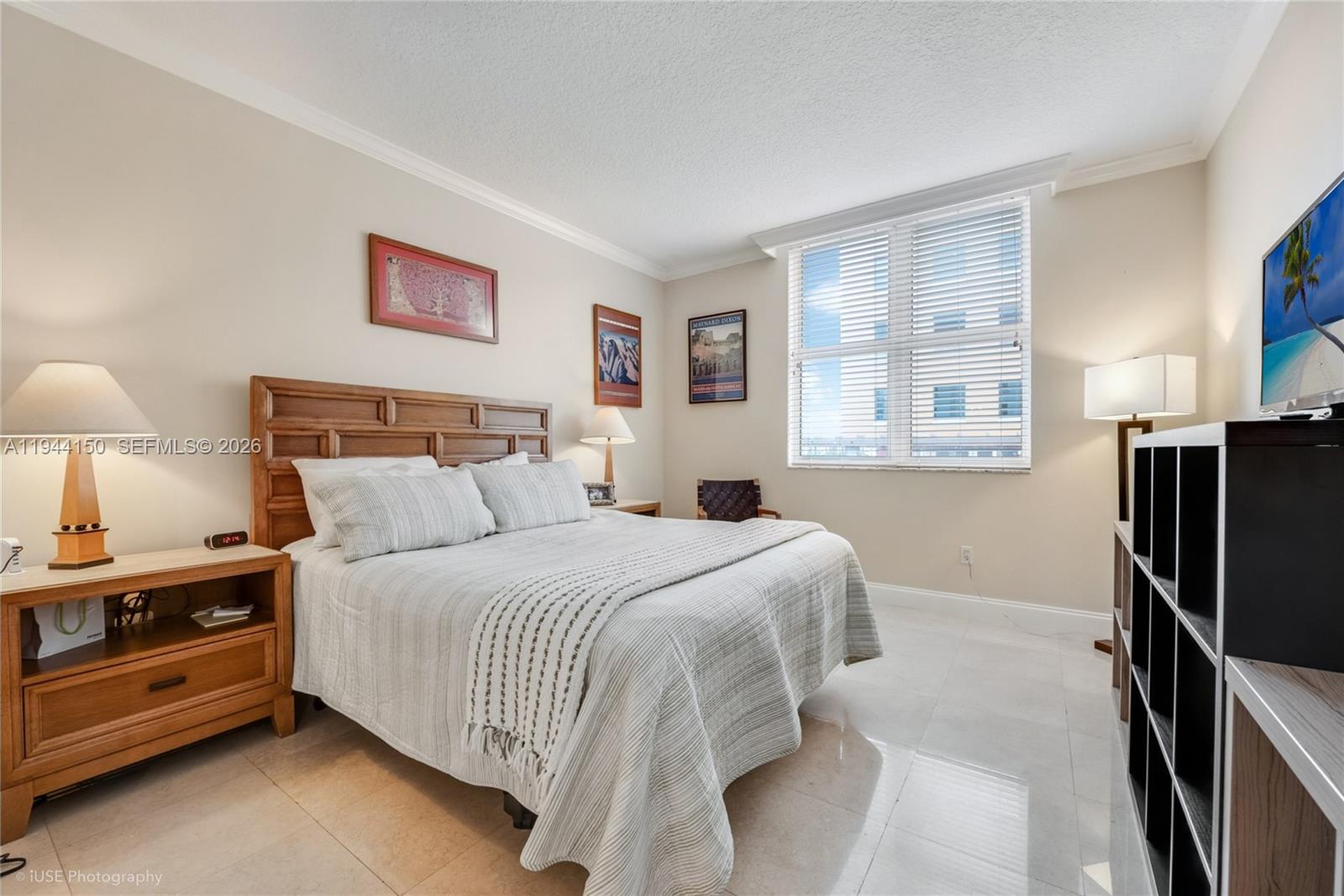 2030 Douglas Road, Unit 511 Coral Gables, FL 33134 - Photo 5 of 19 a bedroom with a bed and a night stand