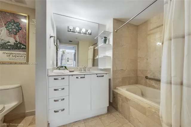 a bathroom with a tub a sink and mirrors