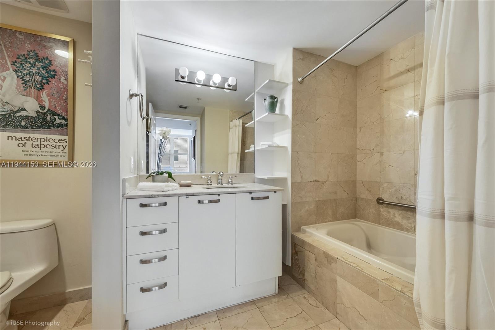 2030 Douglas Road, Unit 511 Coral Gables, FL 33134 - Photo 6 of 19 a bathroom with a tub a sink and mirrors