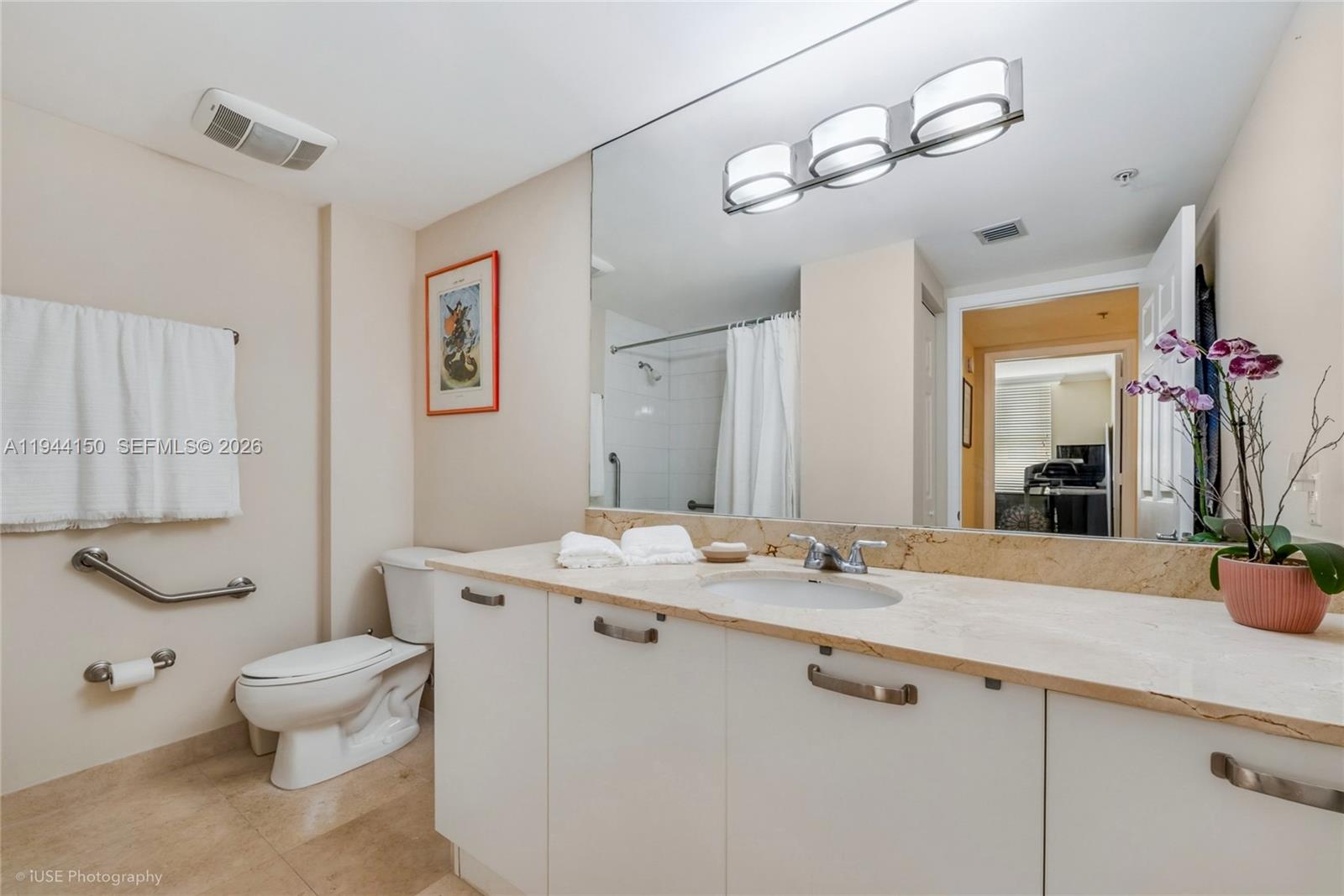 2030 Douglas Road, Unit 511 Coral Gables, FL 33134 - Photo 10 of 19 a bathroom with a sink a toilet and mirror