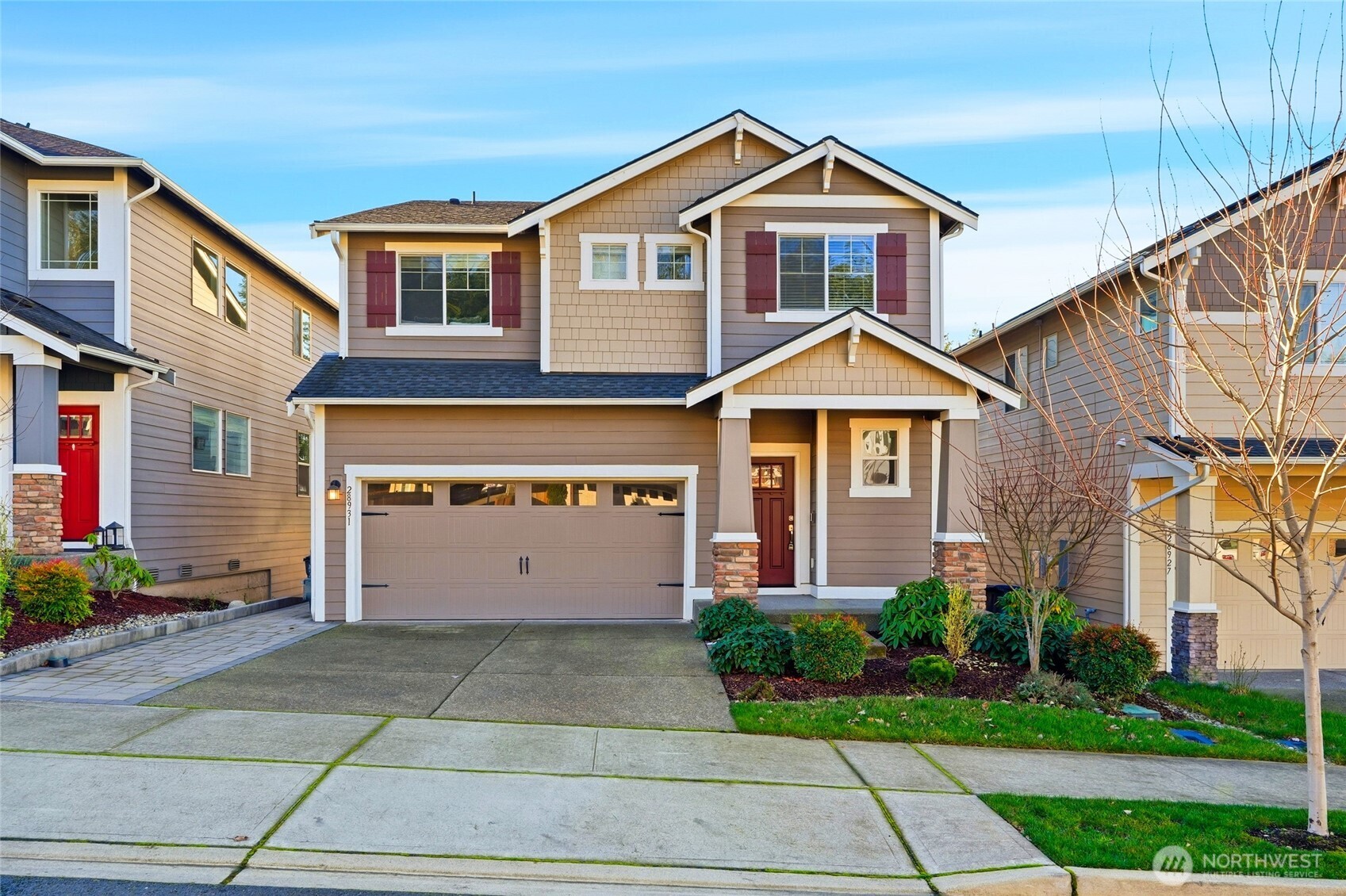 28931 239th Avenue Southeast Maple Valley, WA 98010 - Photo 1 of 37 a front view of a house with a yard and garage