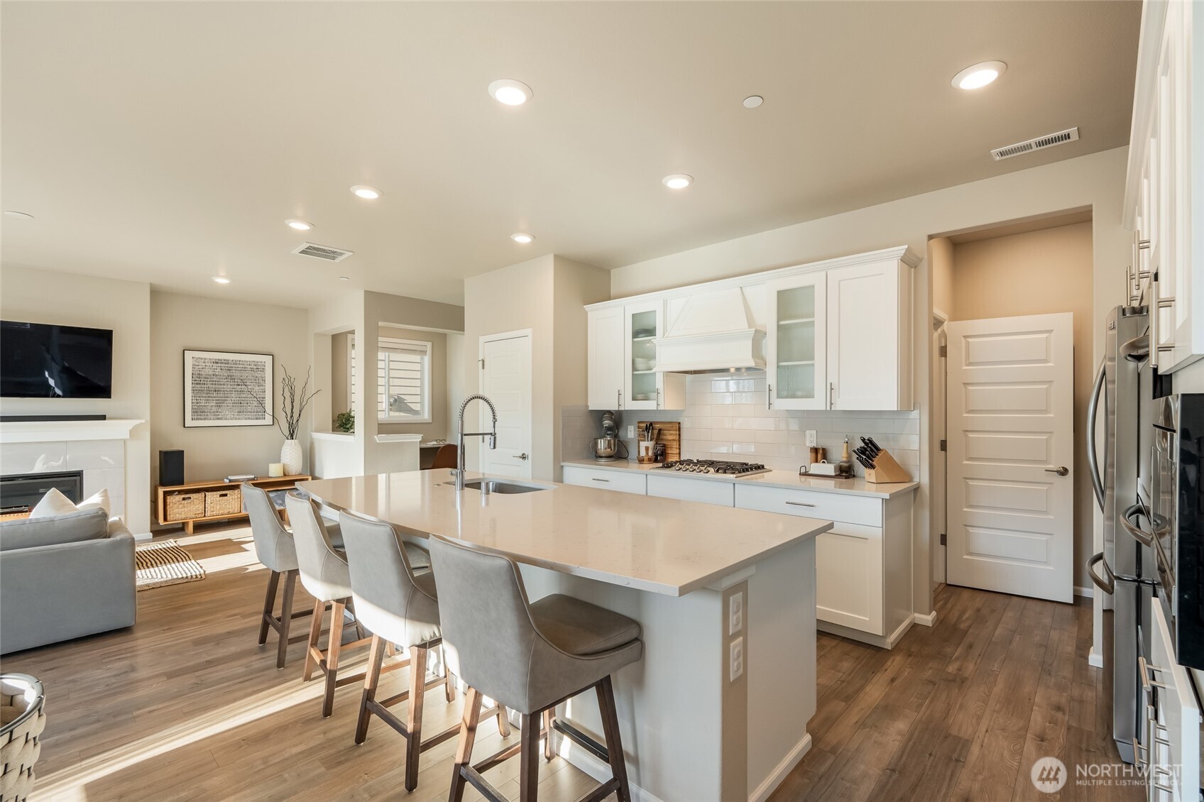 28931 239th Avenue Southeast Maple Valley, WA 98010 - Photo 13 of 37 a kitchen with a dining table chairs refrigerator and cabinets