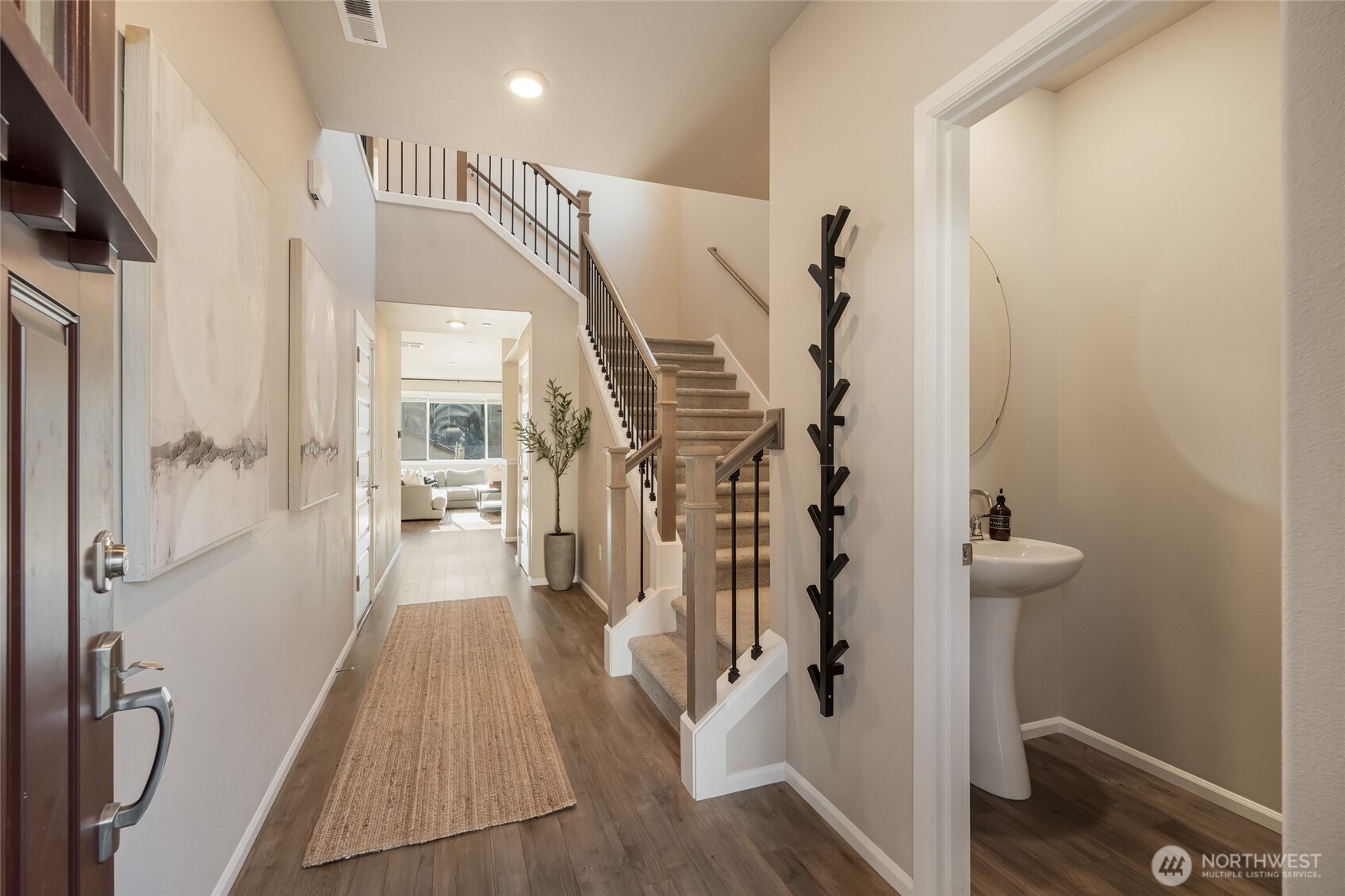 28931 239th Avenue Southeast Maple Valley, WA 98010 - Photo 14 of 37 a view of a hallway with wooden floor and staircase