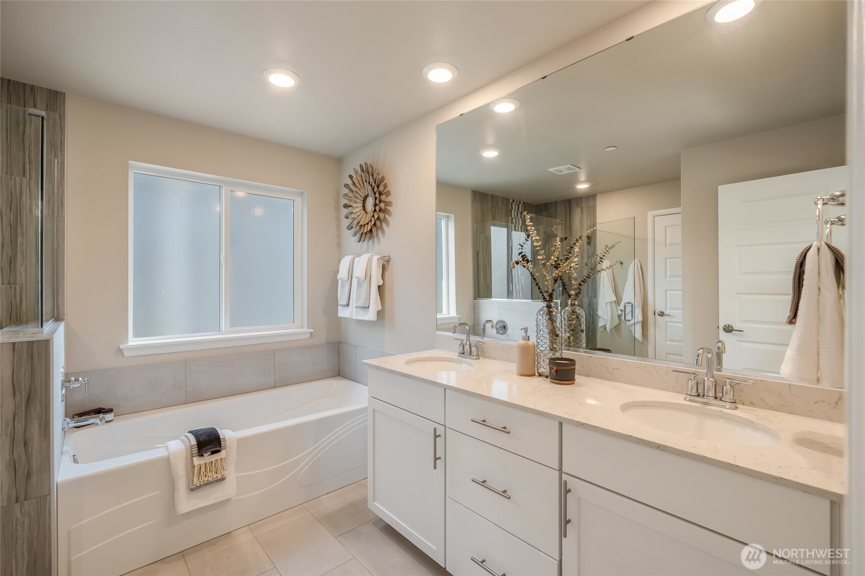 28931 239th Avenue Southeast Maple Valley, WA 98010 - Photo 17 of 37 a spacious bathroom with a double vanity sink a mirror and a bathtub