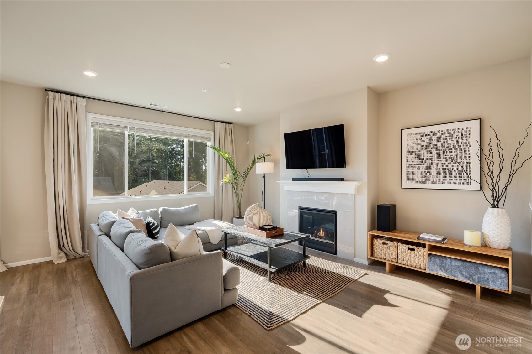 28931 239th Avenue Southeast Maple Valley, WA 98010 - Photo 5 of 37 a living room with furniture a flat screen tv and a fireplace