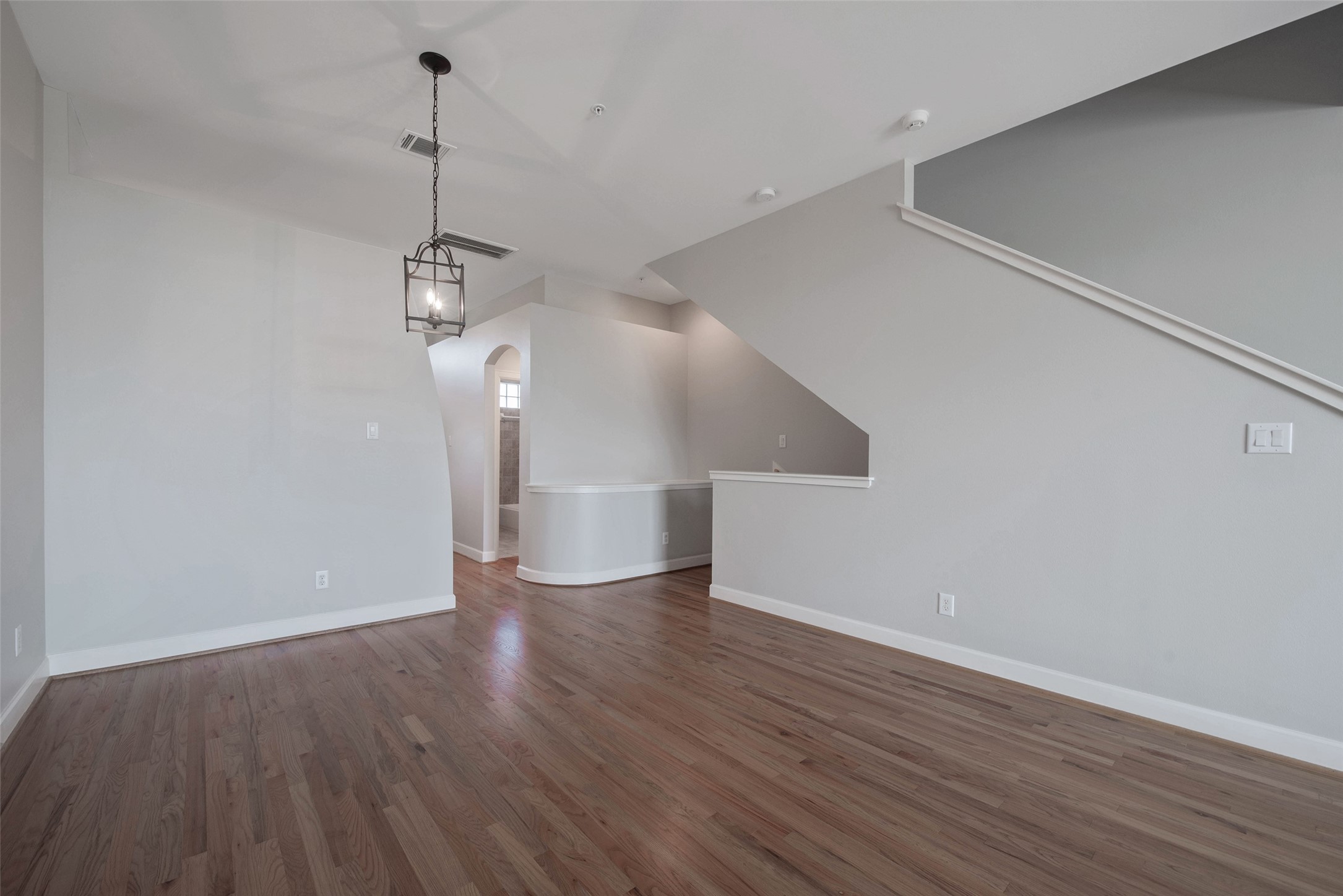 7650 Springhill Street, Unit 603 Houston, TX 77021 - Photo 3 of 26 a view of empty room with wooden floor and ceiling fan