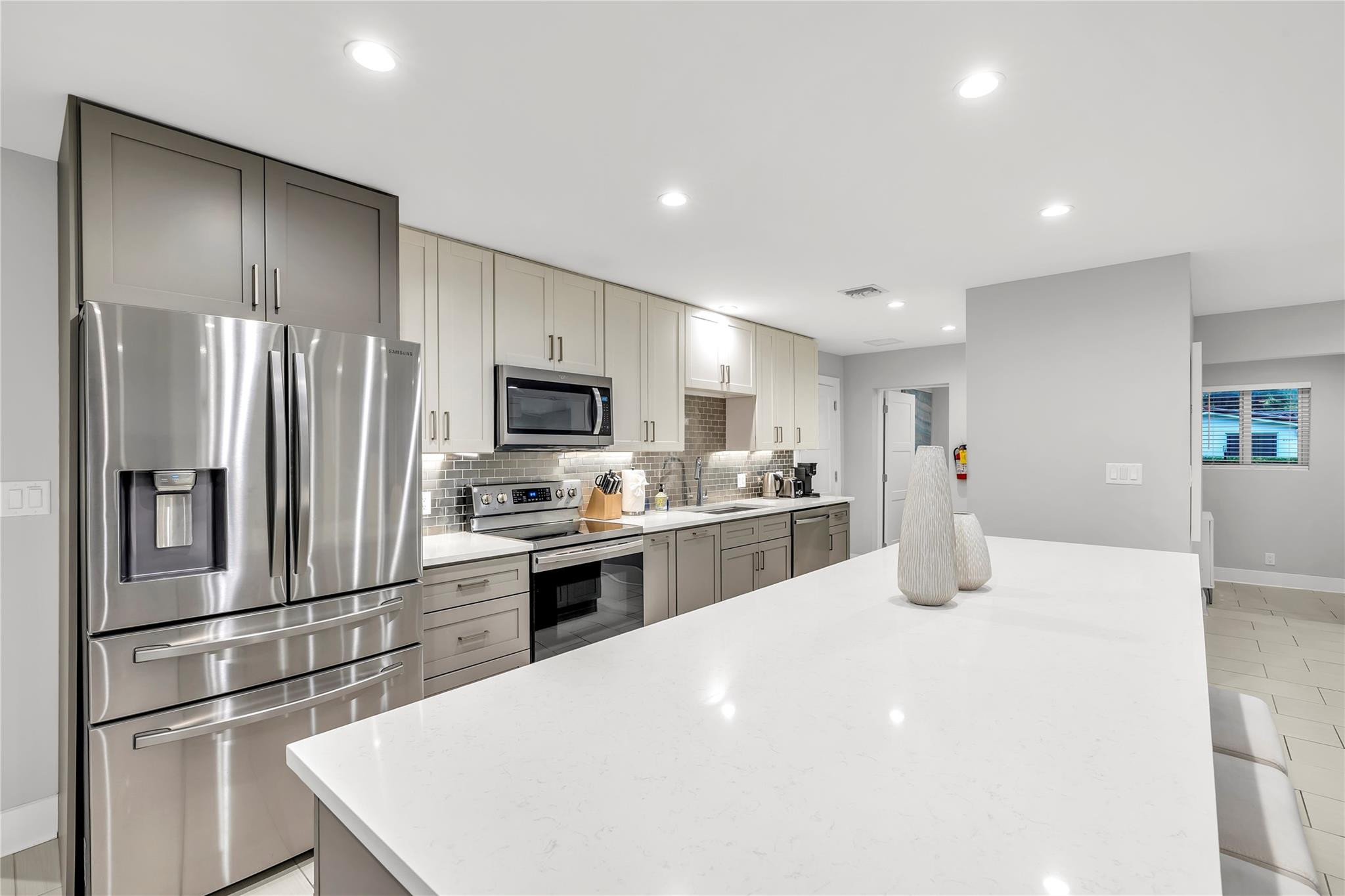 2120 Northeast 34th Court Lighthouse Point, FL 33064 - Photo 11 of 34 a kitchen with stainless steel appliances a refrigerator stove microwave and cabinets
