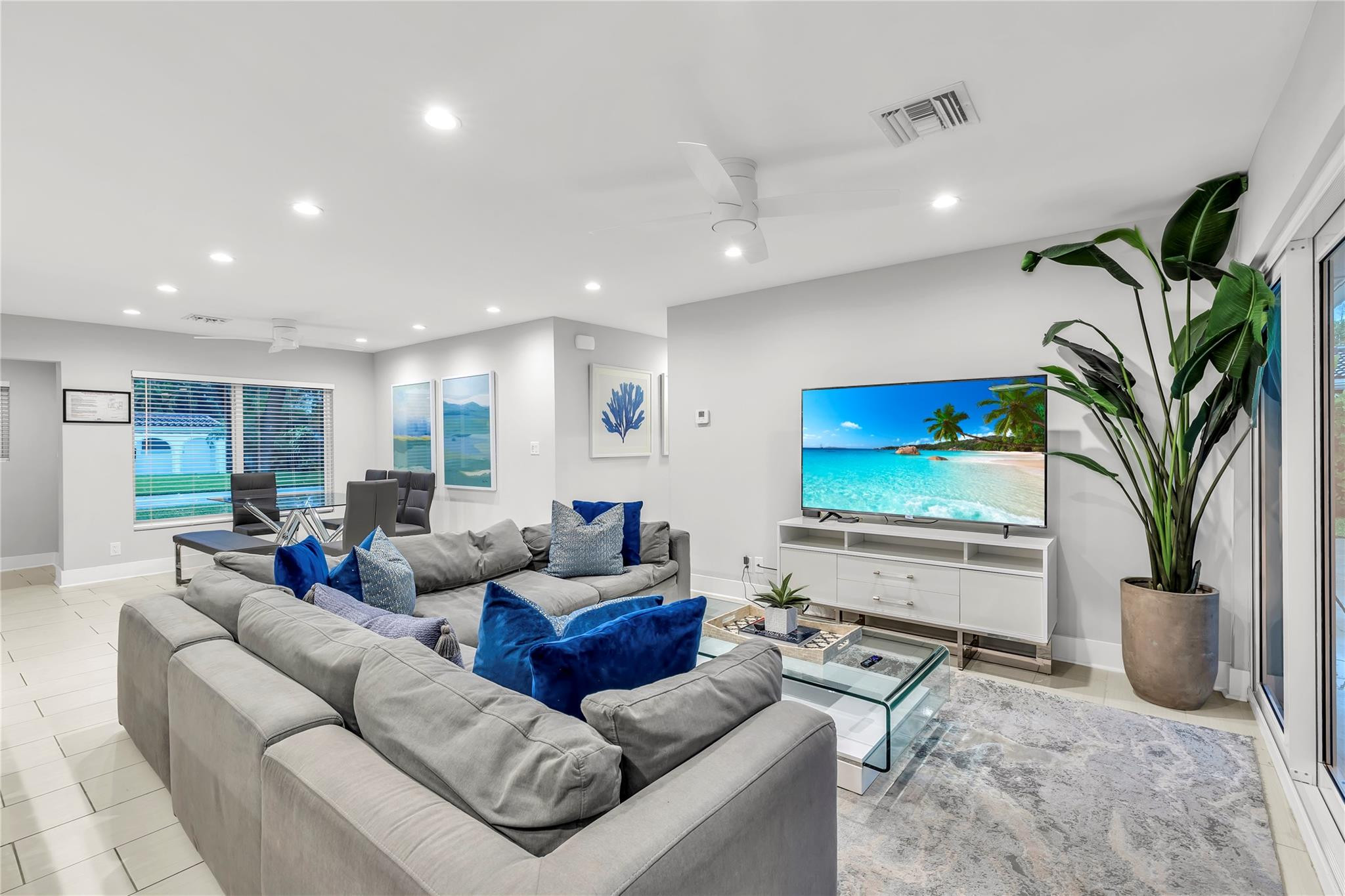 2120 Northeast 34th Court Lighthouse Point, FL 33064 - Photo 15 of 34 a living room with furniture a large window and a flat screen tv