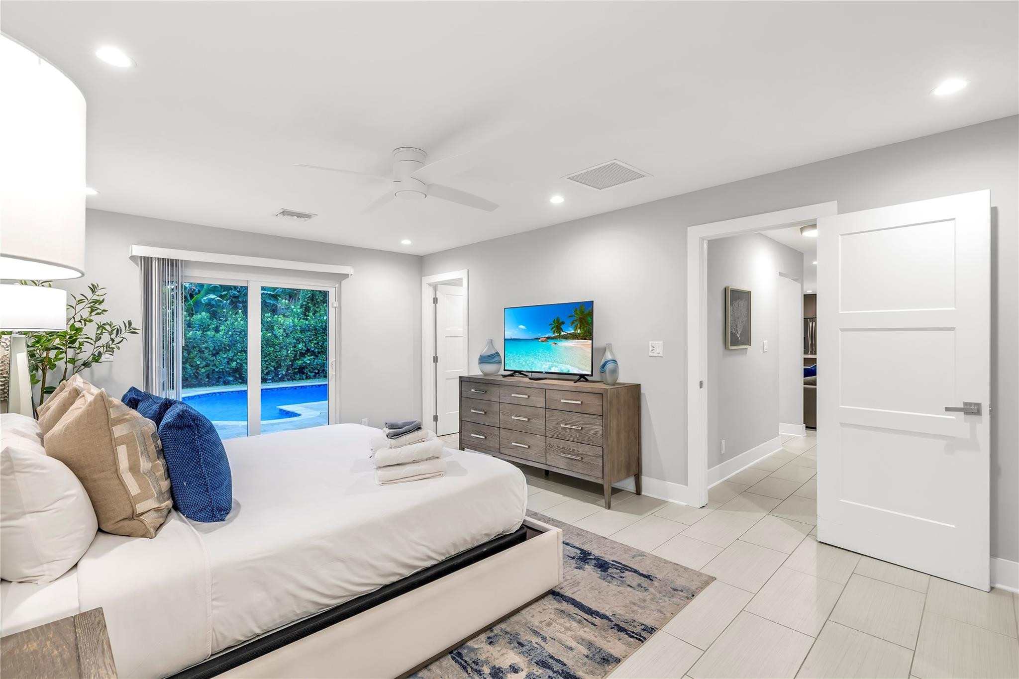 2120 Northeast 34th Court Lighthouse Point, FL 33064 - Photo 20 of 34 a large bedroom with a balcony a bed and a large window