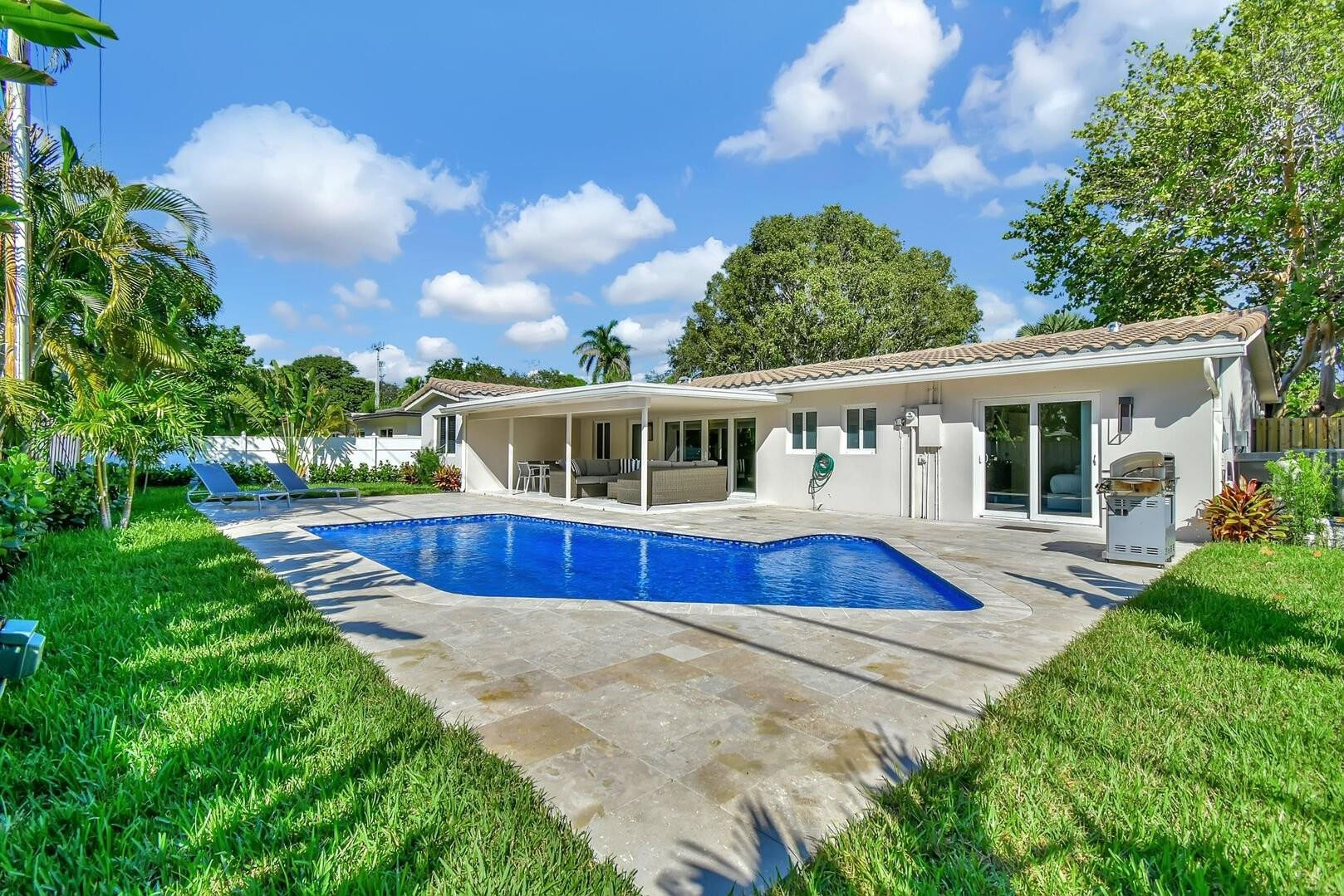 2120 Northeast 34th Court Lighthouse Point, FL 33064 - Photo 2 of 34 a view of house with a swimming pool