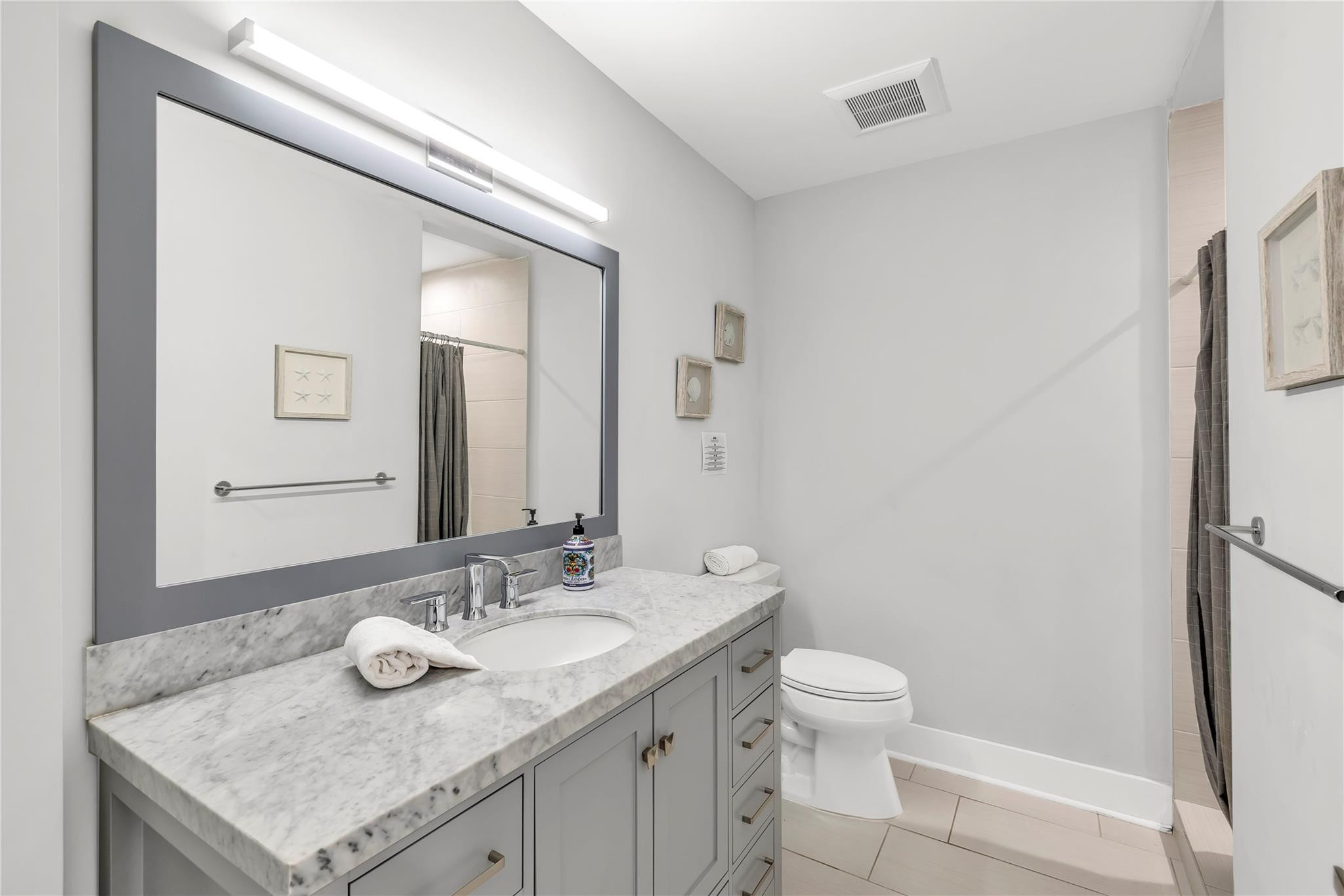 2120 Northeast 34th Court Lighthouse Point, FL 33064 - Photo 23 of 34 a bathroom with a granite countertop sink and a mirror