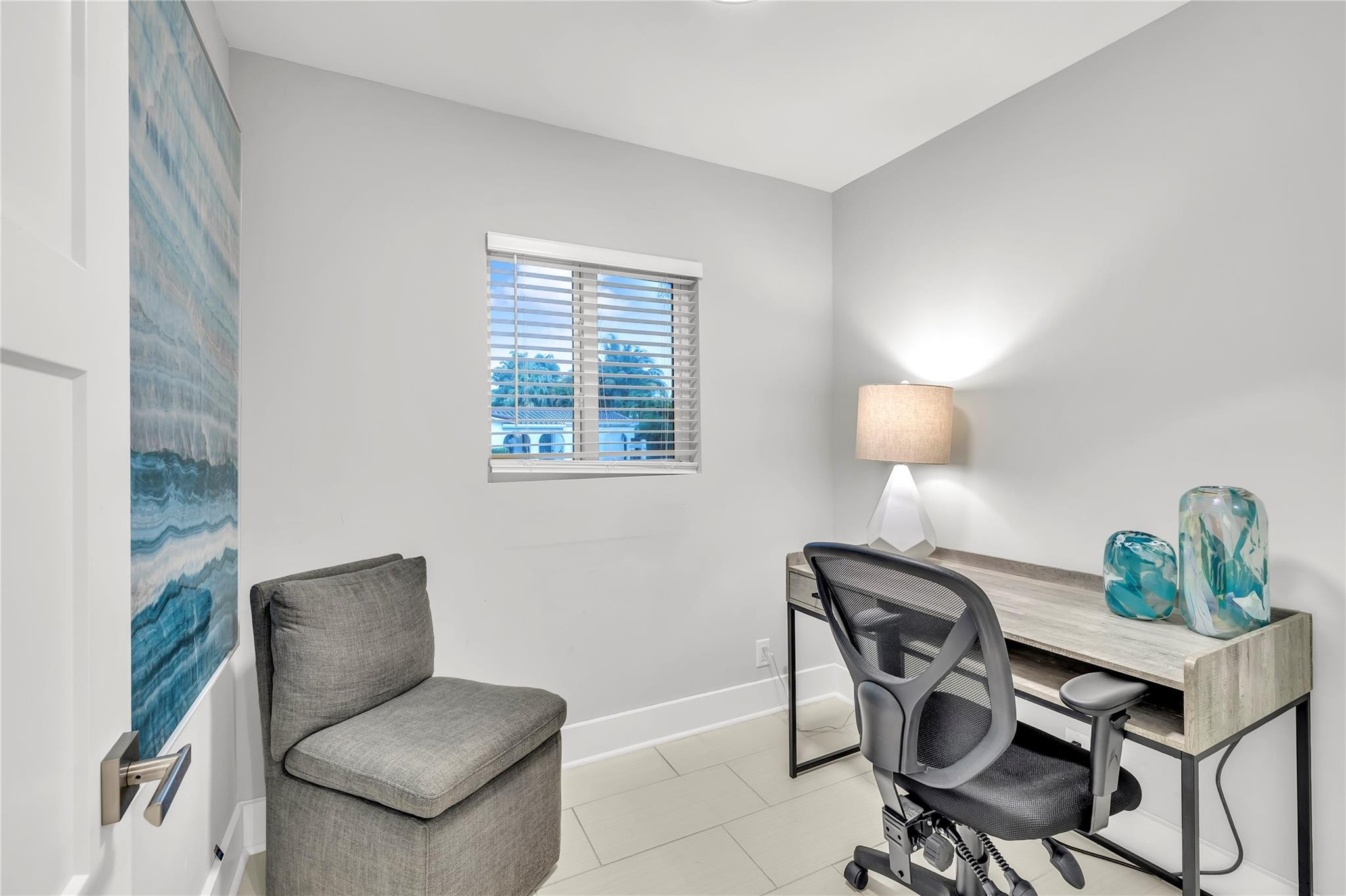 2120 Northeast 34th Court Lighthouse Point, FL 33064 - Photo 25 of 34 a view of a workspace with furniture and a potted plant
