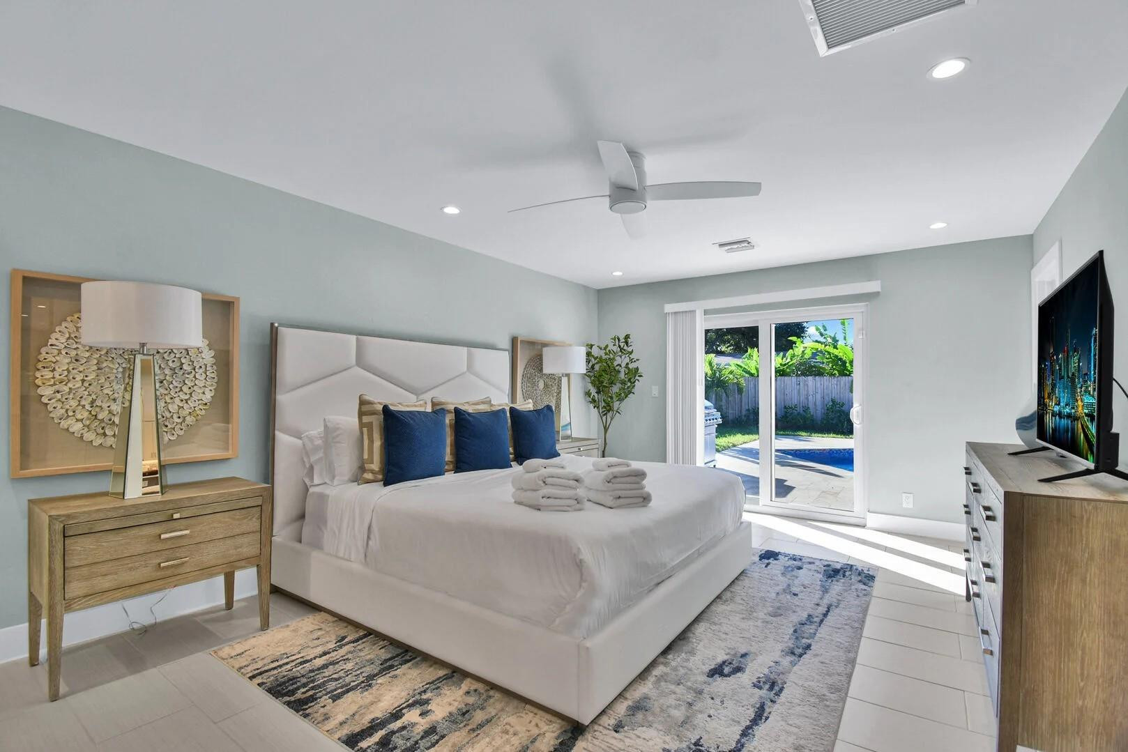 2120 Northeast 34th Court Lighthouse Point, FL 33064 - Photo 28 of 34 a bedroom with a large bed and a flat tv screen