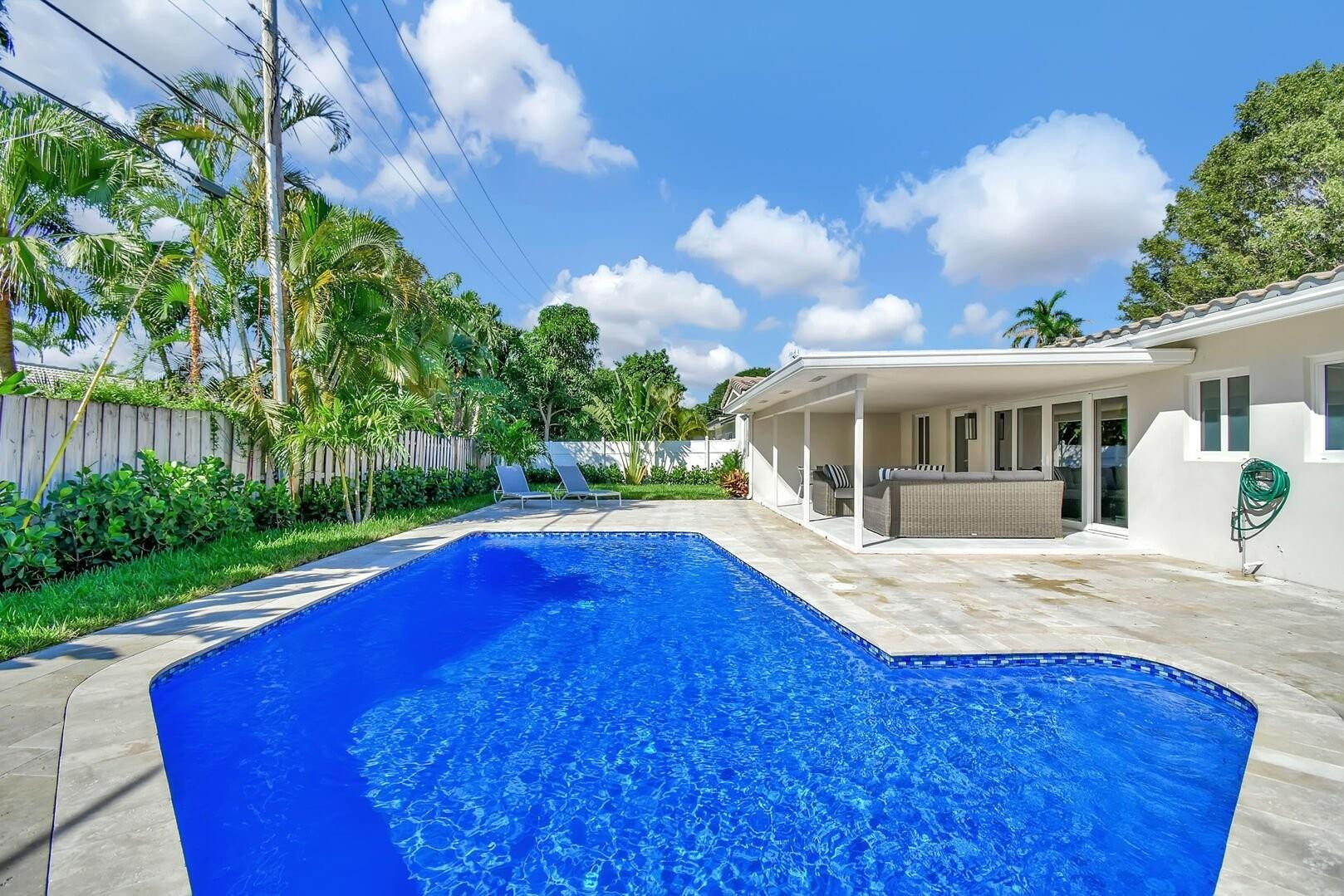2120 Northeast 34th Court Lighthouse Point, FL 33064 - Photo 3 of 34 a view of house with yard and swimming pool