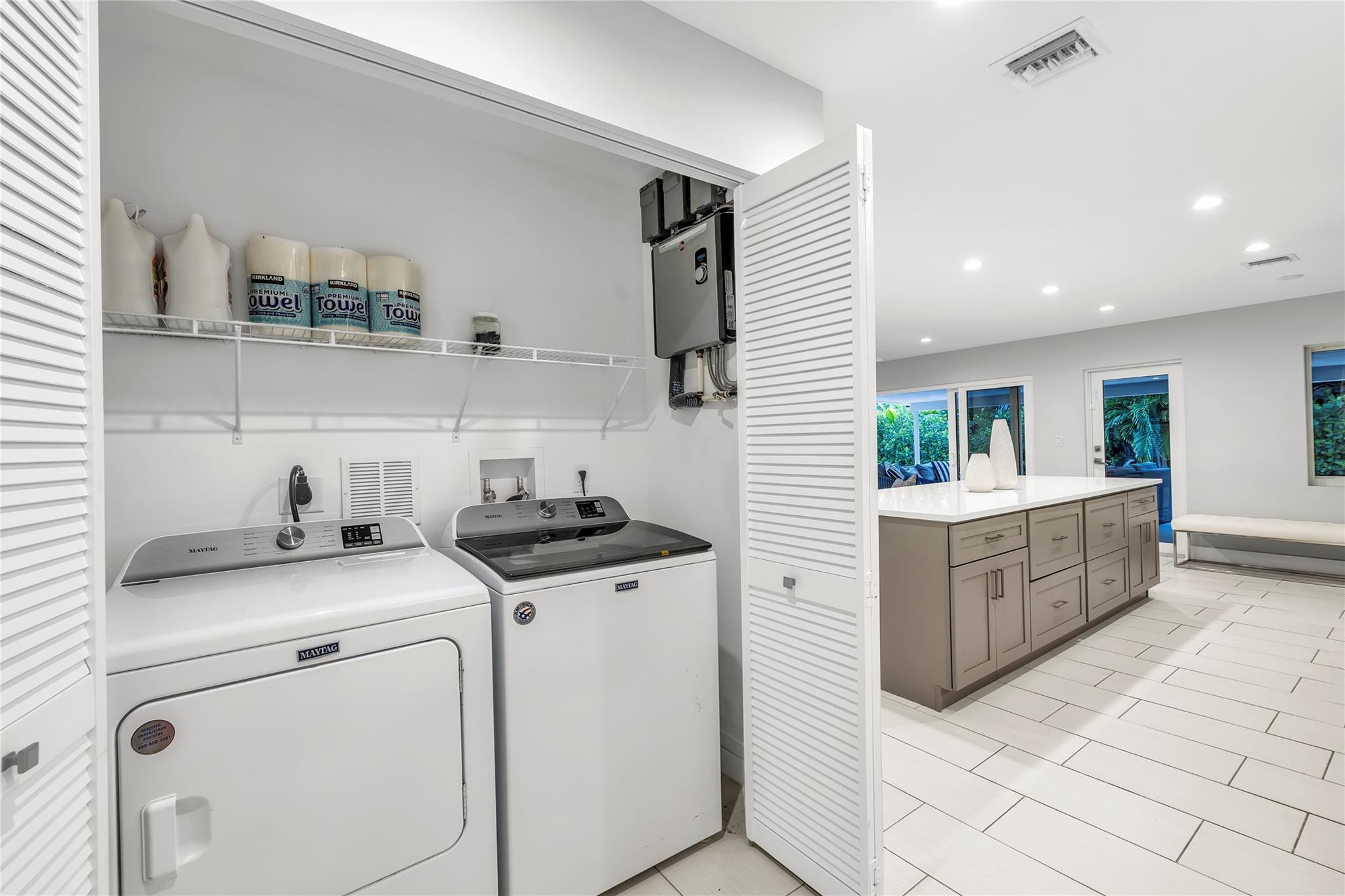 2120 Northeast 34th Court Lighthouse Point, FL 33064 - Photo 31 of 34 a kitchen with a stove cabinets and wooden floor
