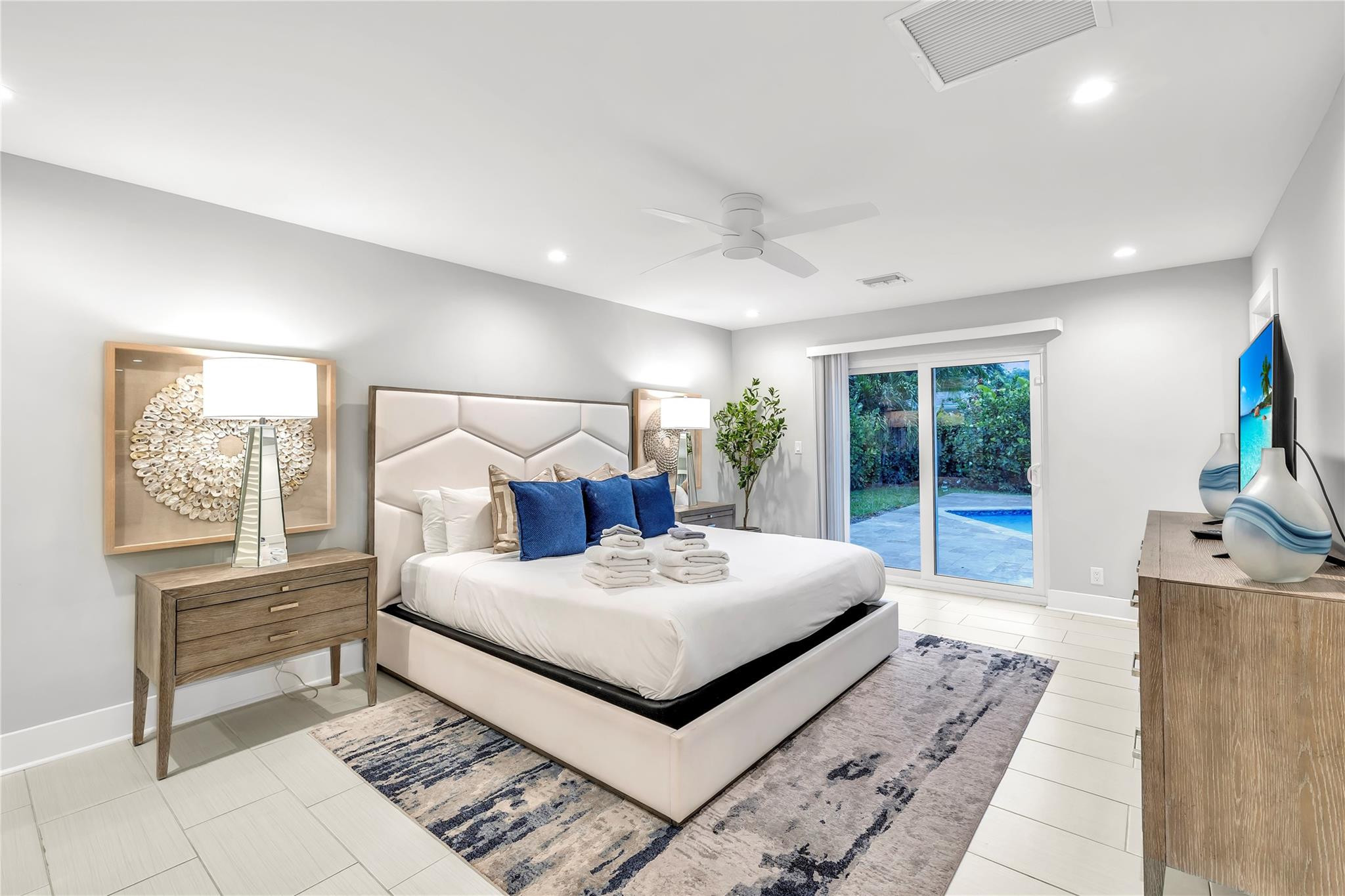 2120 Northeast 34th Court Lighthouse Point, FL 33064 - Photo 5 of 34 a bedroom with a bed and a large window