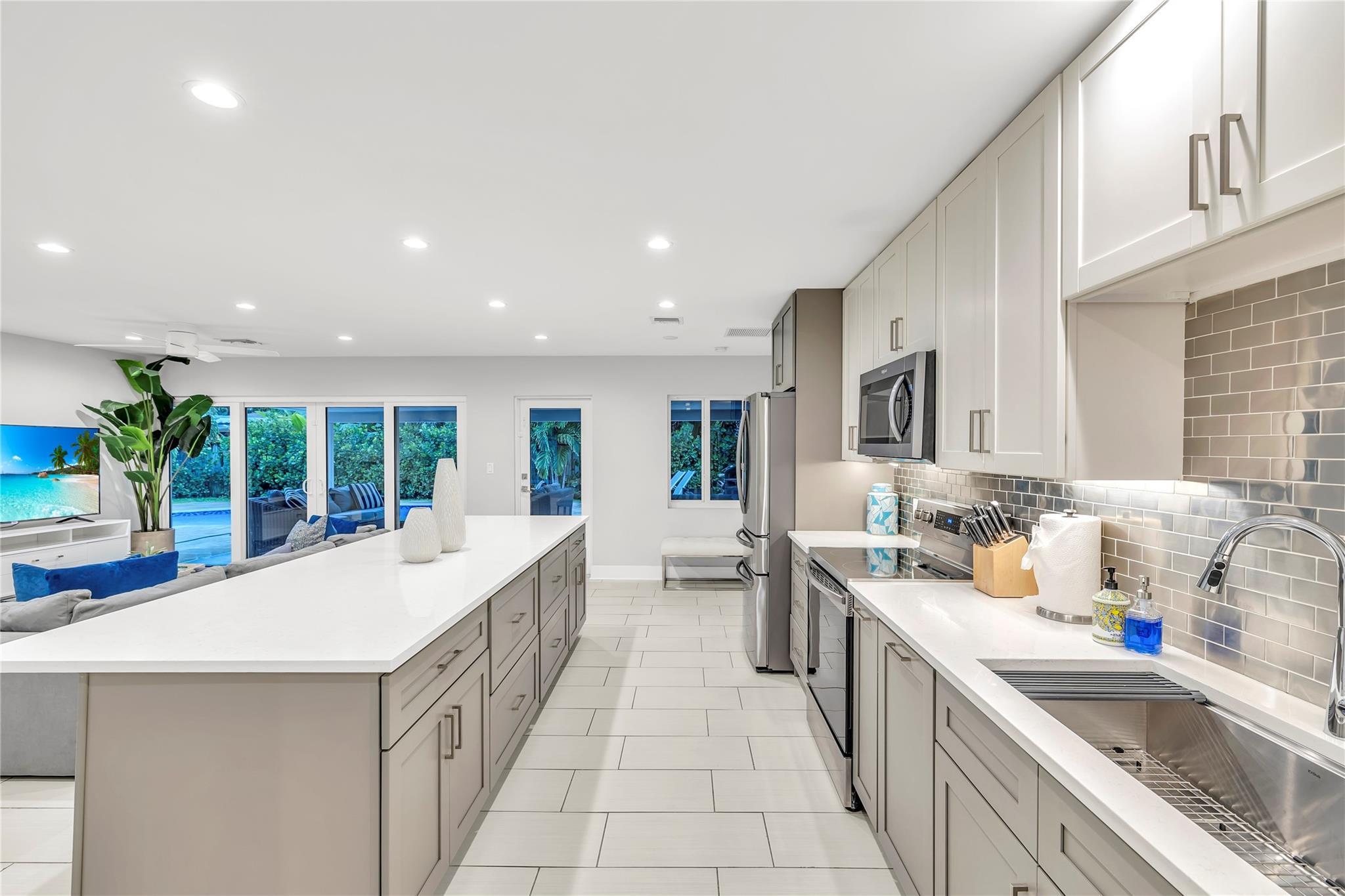 2120 Northeast 34th Court Lighthouse Point, FL 33064 - Photo 8 of 34 a large white kitchen with a large window