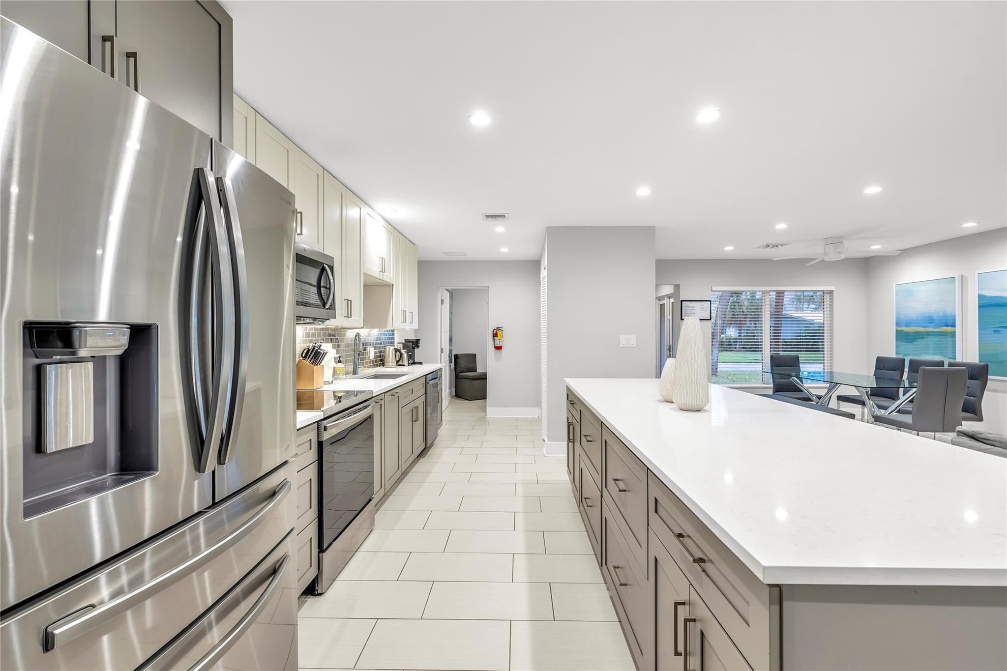 2120 Northeast 34th Court Lighthouse Point, FL 33064 - Photo 9 of 34 a large kitchen with stainless steel appliances a sink and a refrigerator