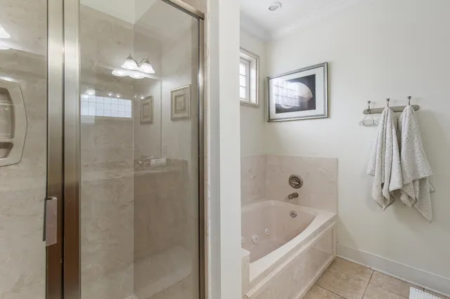 a bathroom with a tub a shower and a sink