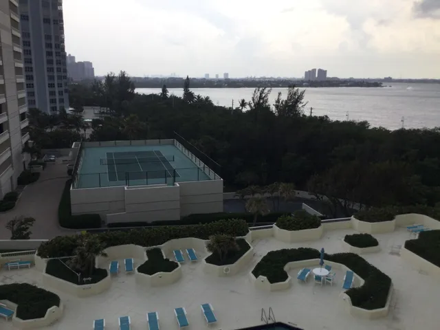 a room with pool table and windows
