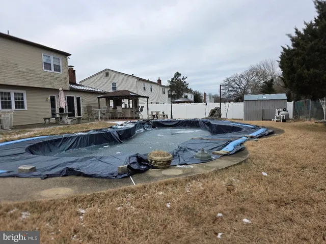 a view of a house with wooden fence