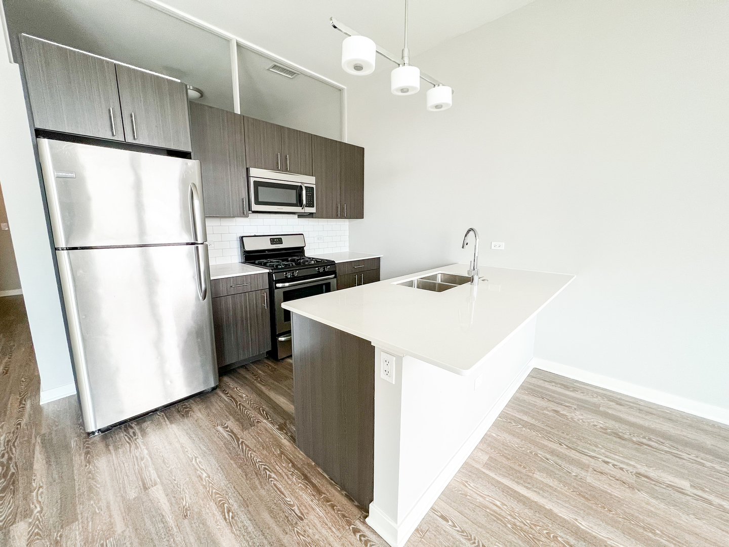 Undisclosed Address Chicago, IL 60642 - Photo 5 of 13 a kitchen with kitchen island a sink stainless steel appliances and refrigerator