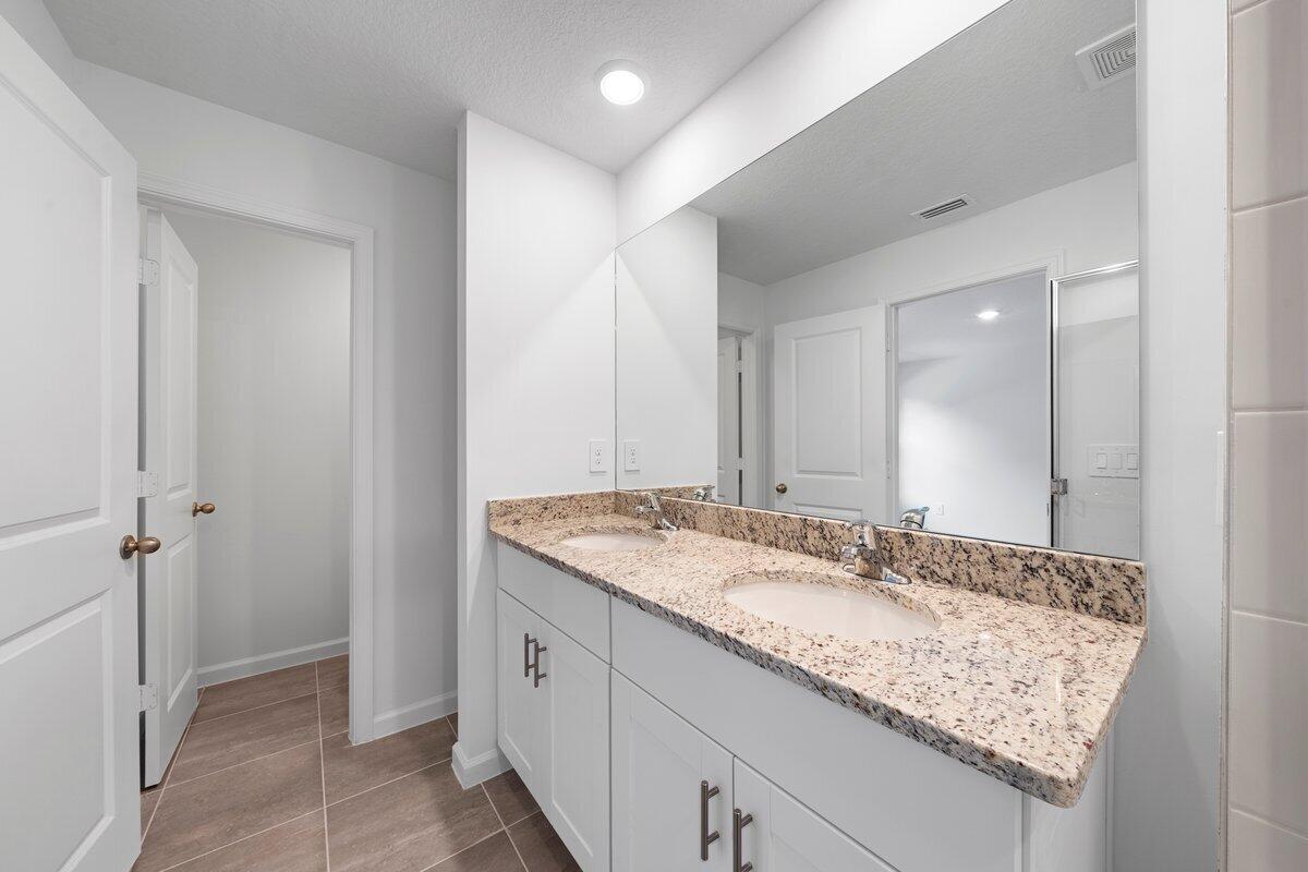474 Salisbury Circle Fort Pierce, FL 34982 - Photo 14 of 17 a bathroom with a granite countertop sink and a mirror