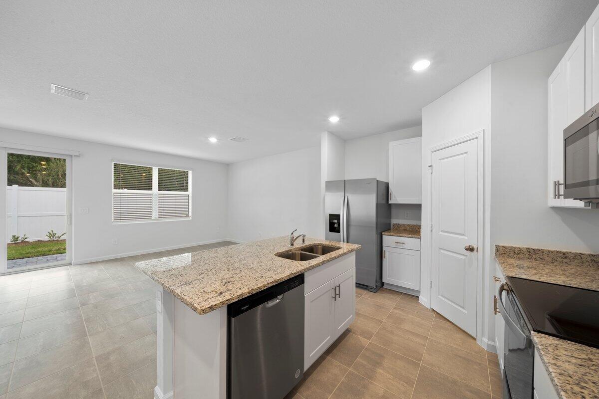 474 Salisbury Circle Fort Pierce, FL 34982 - Photo 5 of 17 a kitchen with refrigerator and cabinets