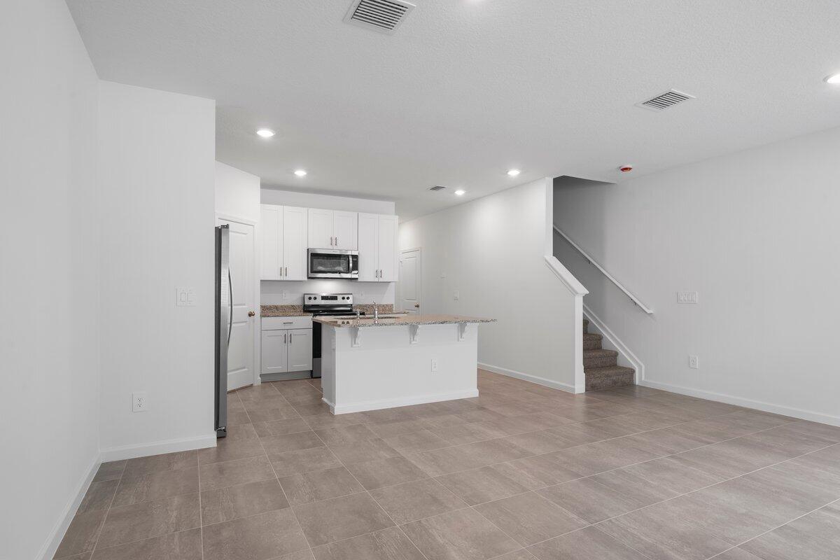 474 Salisbury Circle Fort Pierce, FL 34982 - Photo 6 of 17 a view of kitchen with refrigerator and microwave