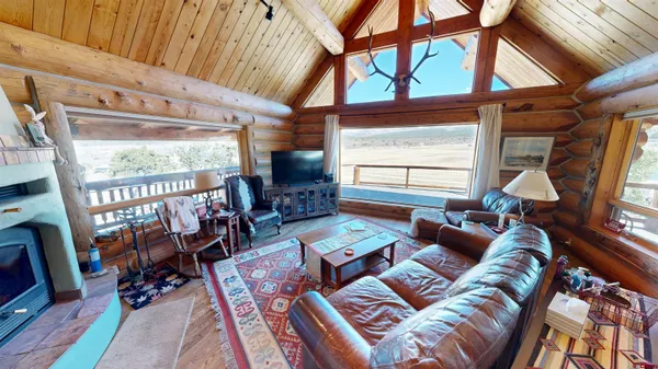 a living room with furniture a window and a flat screen tv