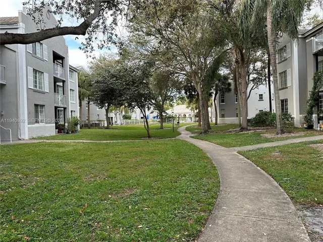a view of a house with swimming pool and sitting area