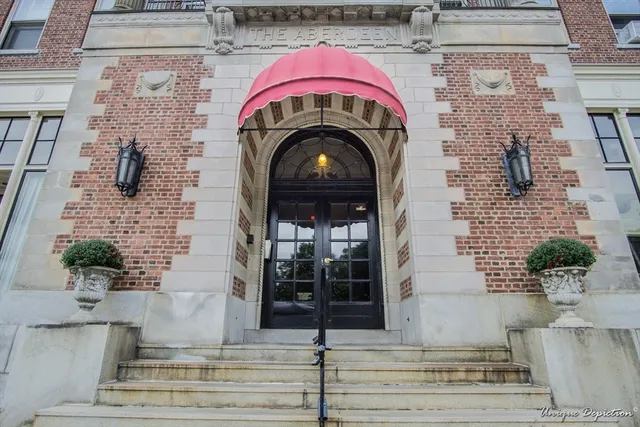 a view of building with glass windows and potted plants