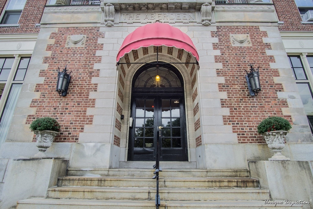354 North Main Street, Unit 303 Andover, MA 01810 - Photo 1 of 16 a view of building with glass windows and potted plants