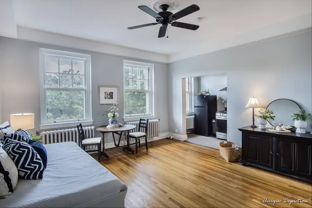a living room with furniture and a wooden floor