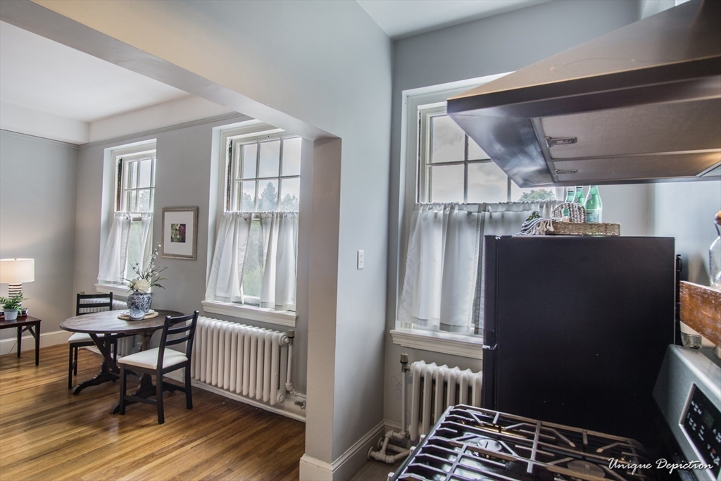 354 North Main Street, Unit 303 Andover, MA 01810 - Photo 12 of 16 a view of a dining room with furniture window and wooden floor