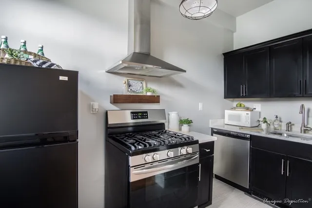 a kitchen with stainless steel appliances kitchen island a stove and a refrigerator