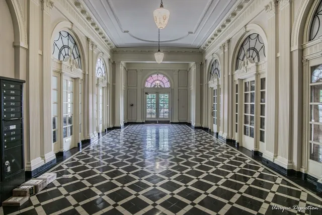 a view of a entryway door with furniture and chandelier