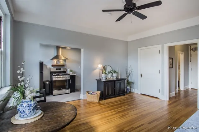 a living room with furniture and a dining table