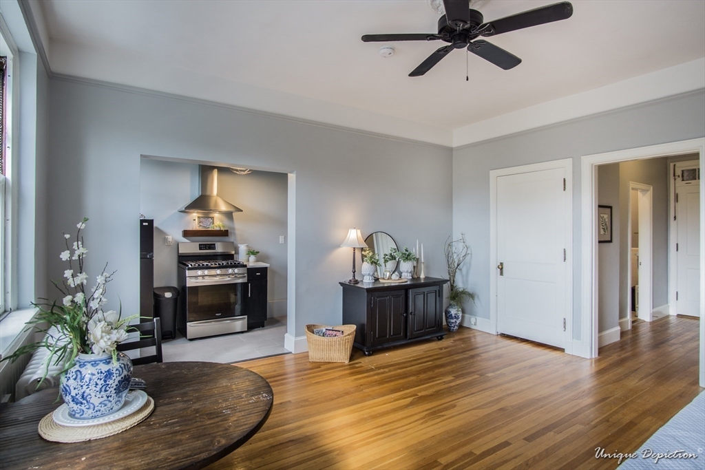 354 North Main Street, Unit 303 Andover, MA 01810 - Photo 6 of 16 a living room with furniture and a dining table
