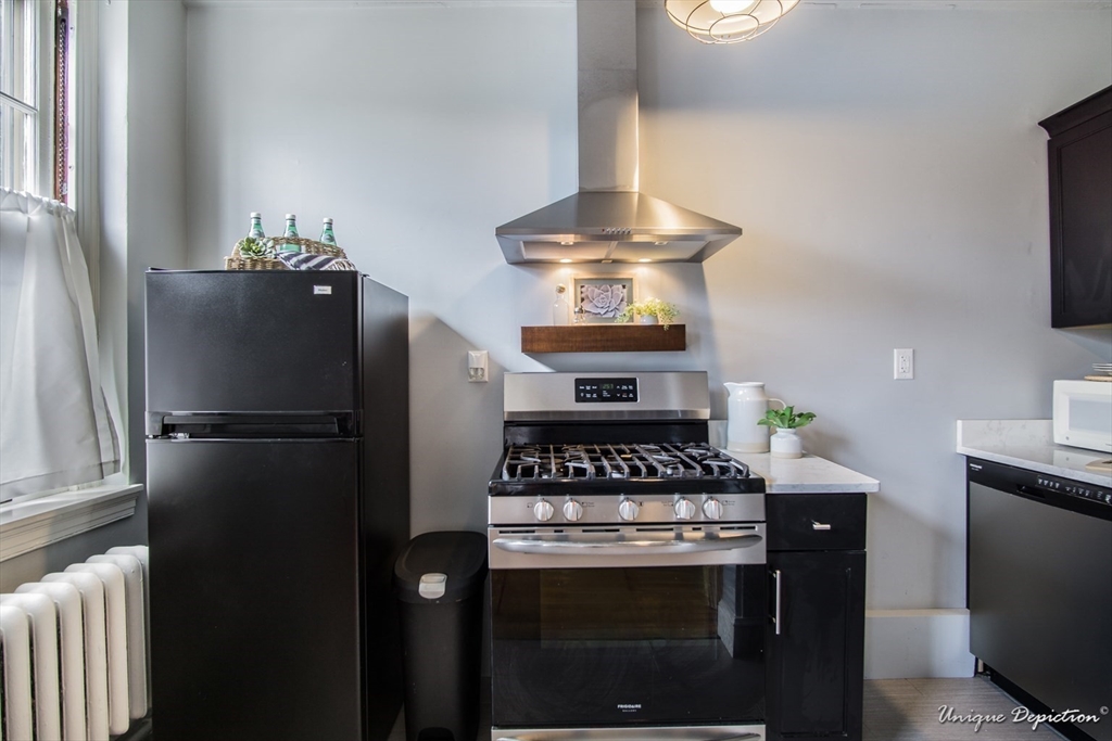 354 North Main Street, Unit 303 Andover, MA 01810 - Photo 7 of 16 a kitchen with a stove and a refrigerator