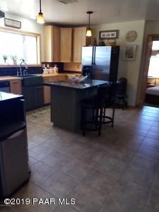 2160 West Storm Road Paulden, AZ 86334 - Photo 3 of 18 a kitchen with stainless steel appliances granite countertop a sink a stove counter space and cabinets