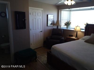 2160 West Storm Road Paulden, AZ 86334 - Photo 7 of 18 a bedroom with a bed and a chandelier