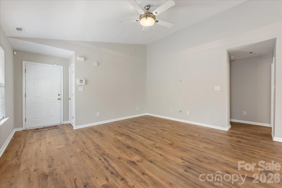 2872 Signal Court Southwest Concord, NC 28025 - Photo 11 of 43 a view of an empty room with wooden floor