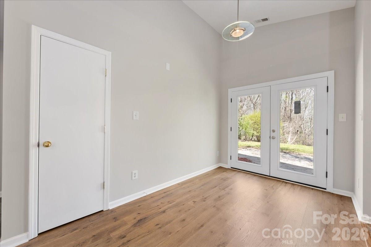 2872 Signal Court Southwest Concord, NC 28025 - Photo 13 of 43 an empty room with wooden floor and windows
