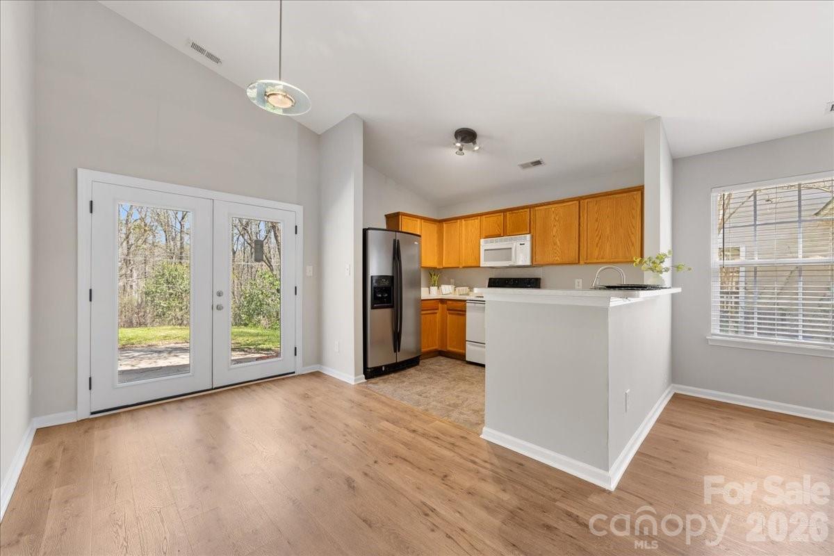 2872 Signal Court Southwest Concord, NC 28025 - Photo 14 of 43 a view of a kitchen with a sink wooden floor and a window