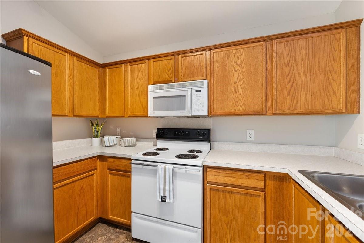 2872 Signal Court Southwest Concord, NC 28025 - Photo 15 of 43 a kitchen with a sink a stove and cabinets