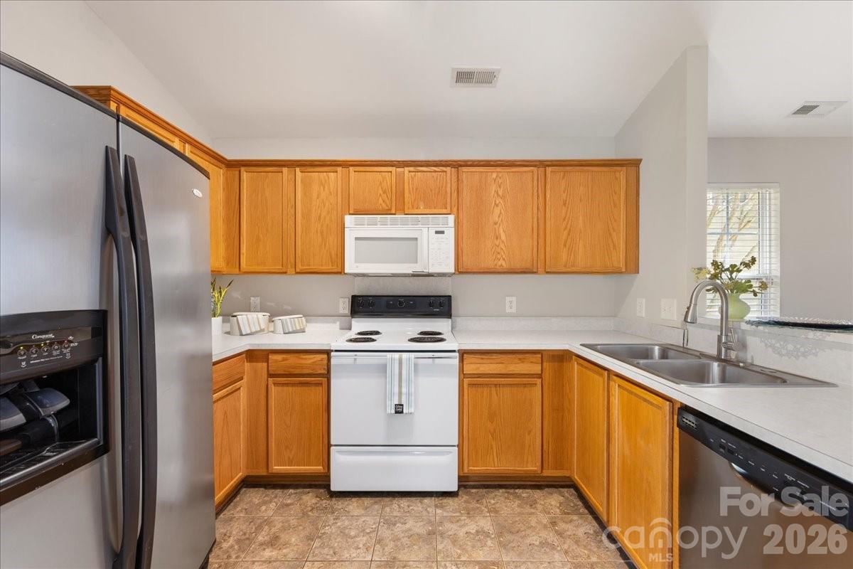 2872 Signal Court Southwest Concord, NC 28025 - Photo 16 of 43 a kitchen with a sink stove and refrigerator